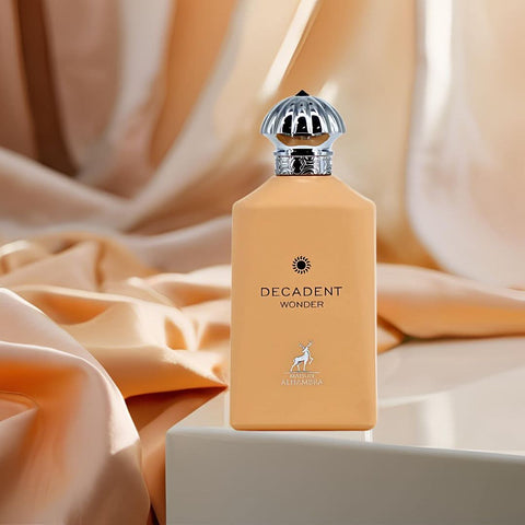 Maison Alhambra Decadent Wonder Eau de Parfum spray 100ml with velvet pouch, elegant glass bottle and fragrance details.