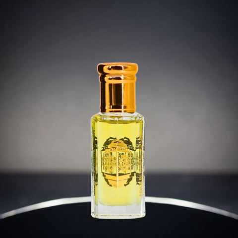 Mukhallat Al Najm perfume oil by Intense Oud in a 12ml bottle with a black gift box, featuring luxurious loose oil display.