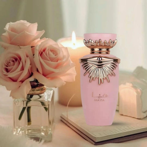 Lattafa Haya Eau de Parfum spray 100ml with velvet pouch, elegant bottle showcasing floral and oriental fragrance notes.