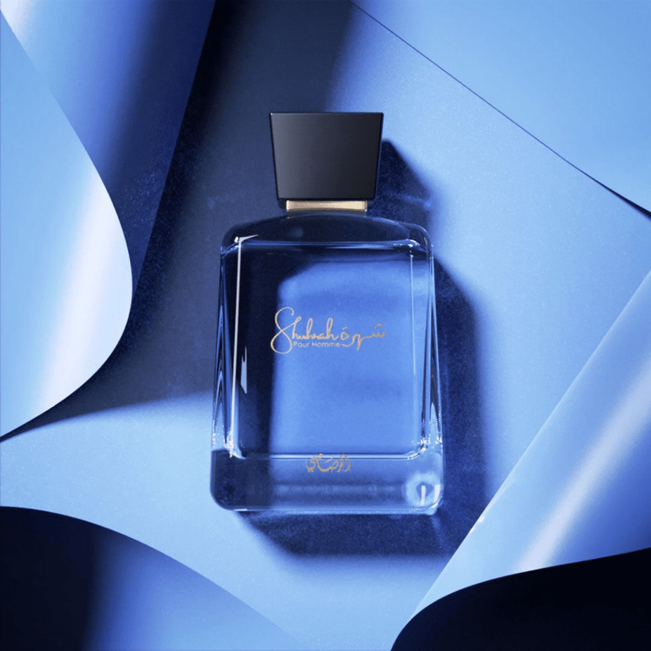 Rasasi Shuhrah Men & Women EDP bundle, 90ml each, featuring elegant perfume bottles with floral and woody fragrance accents.