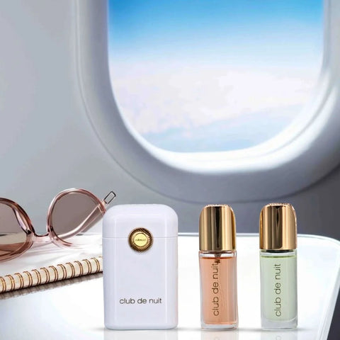 Armaf Club De Nuit Woman parfum travel set with 12ml bottles, including a sleek travel pouch and fragrance bottles.