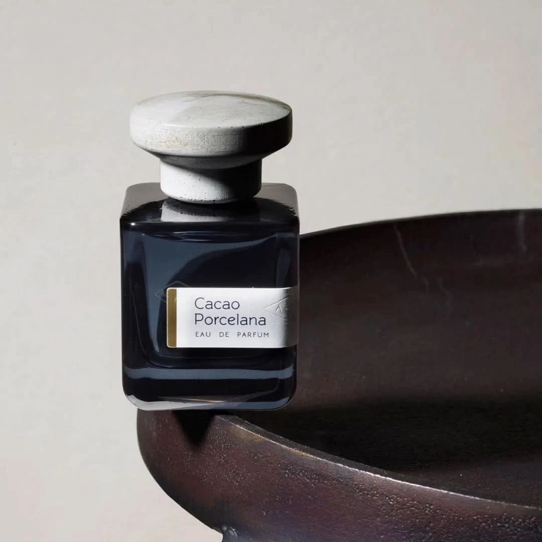 Atelier Materi Cacao Porcelana Eau de Parfum spray bottle, 100ml, featuring elegant packaging and dark chocolate-colored liquid.