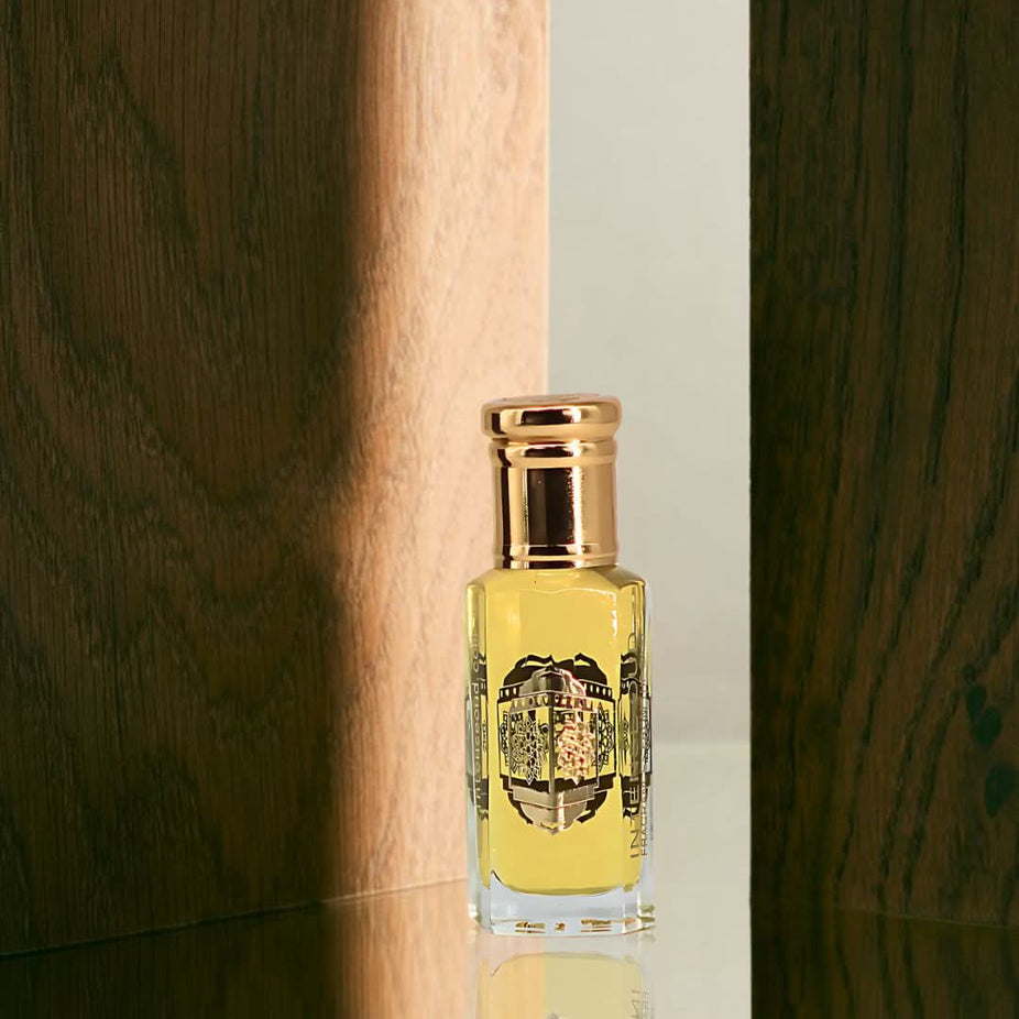 Intense Oud Touch Of Amber perfume oil 12ml in a black gift box, featuring a rich amber scent in a sleek loose oil bottle.