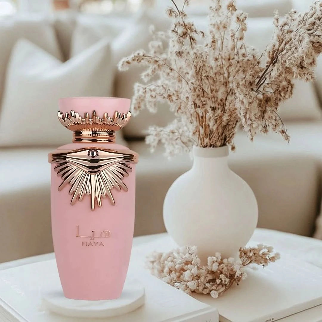 Lattafa Haya Eau de Parfum spray in a 100ml bottle, displayed with an elegant velvet pouch, showcasing the fragrance and packaging.