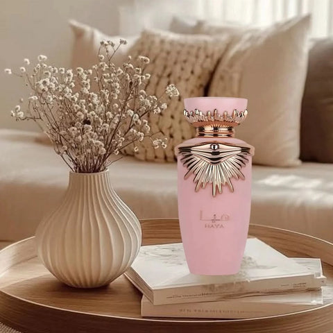 Lattafa Haya Eau de Parfum Spray 100ml in a velvet pouch, showcasing the elegant perfume bottle and packaging.