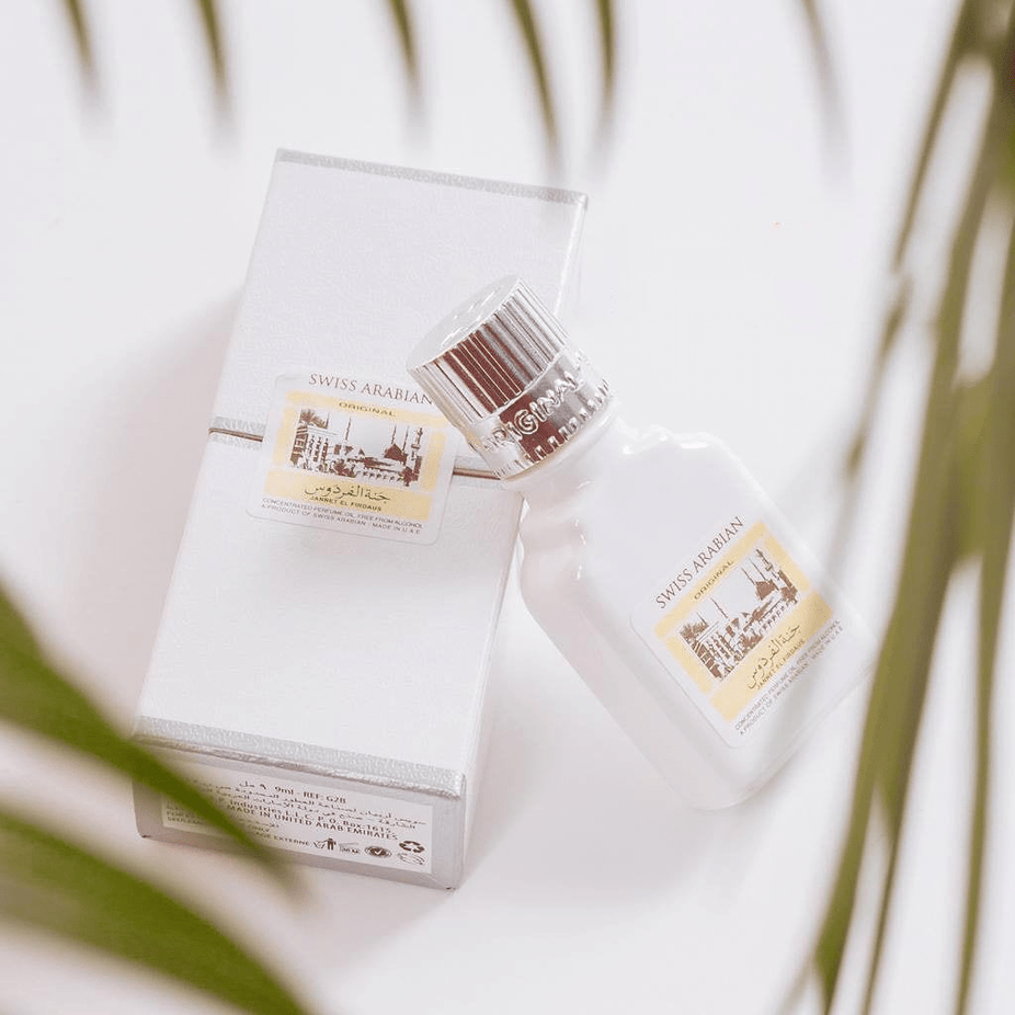 Swiss Arabian Jannet El Firdaus white perfume oil in a 9 ML bottle, showcasing the elegant packaging and clear liquid inside.