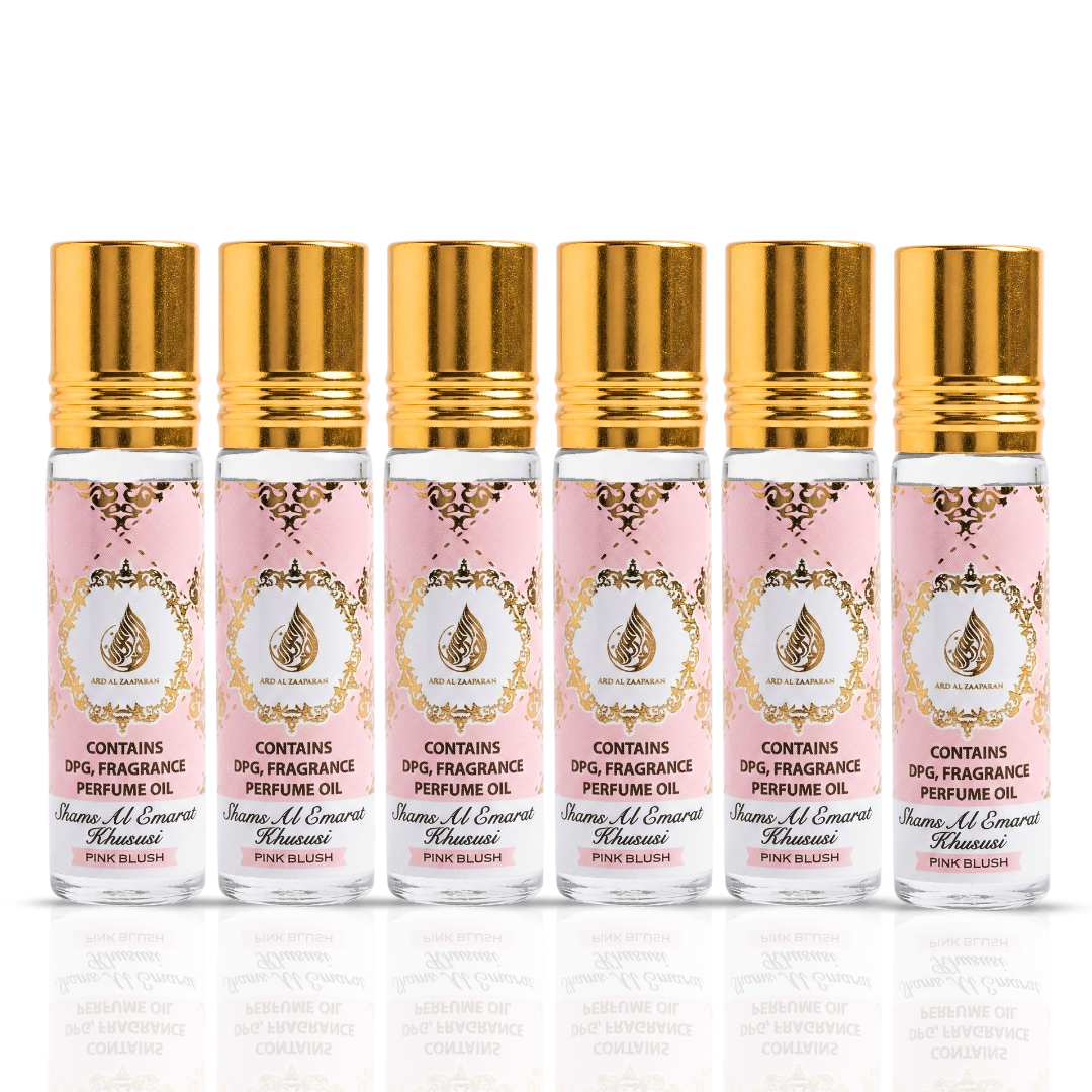 Pack of three Pink Blush Shams Al Emarat Khususi roll-on perfume oils by Ard Al Zaafaran, 10ml each, in a clear display.
