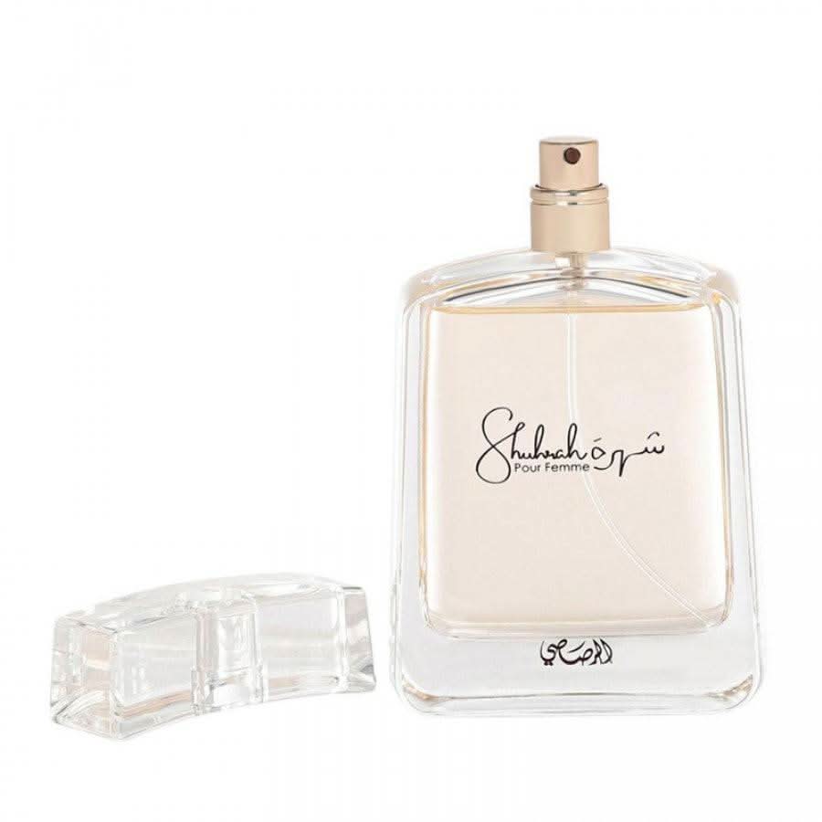 Rasasi Shuhrah for Women EDP 90ml perfume in a velvet pouch, showcasing the elegant bottle and luxurious packaging.