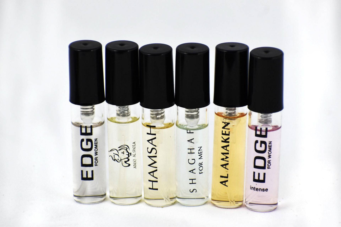 Set of Swiss Arabian perfume samples including women’s Areej Al Sheila, Hamsah, Shaghaf Men, and Amaken fragrances.