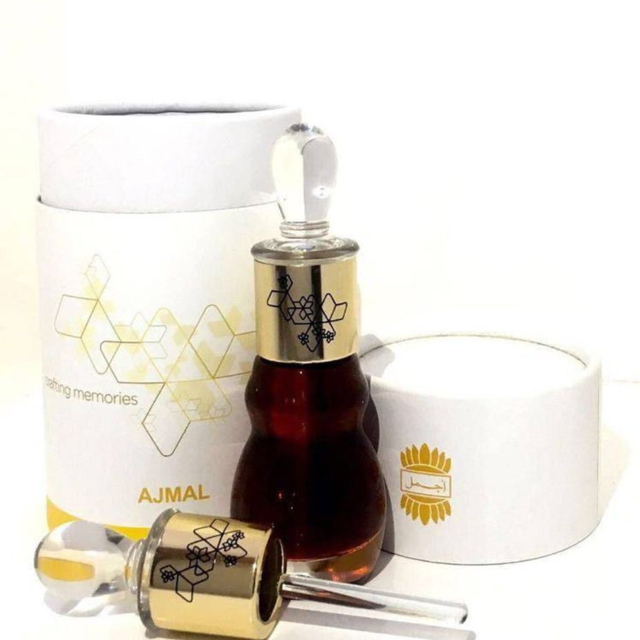 Ajmal Royal Velvet Perfume Oil 12ml in a clear glass bottle, showcasing the luxurious loose oil with a black cap.
