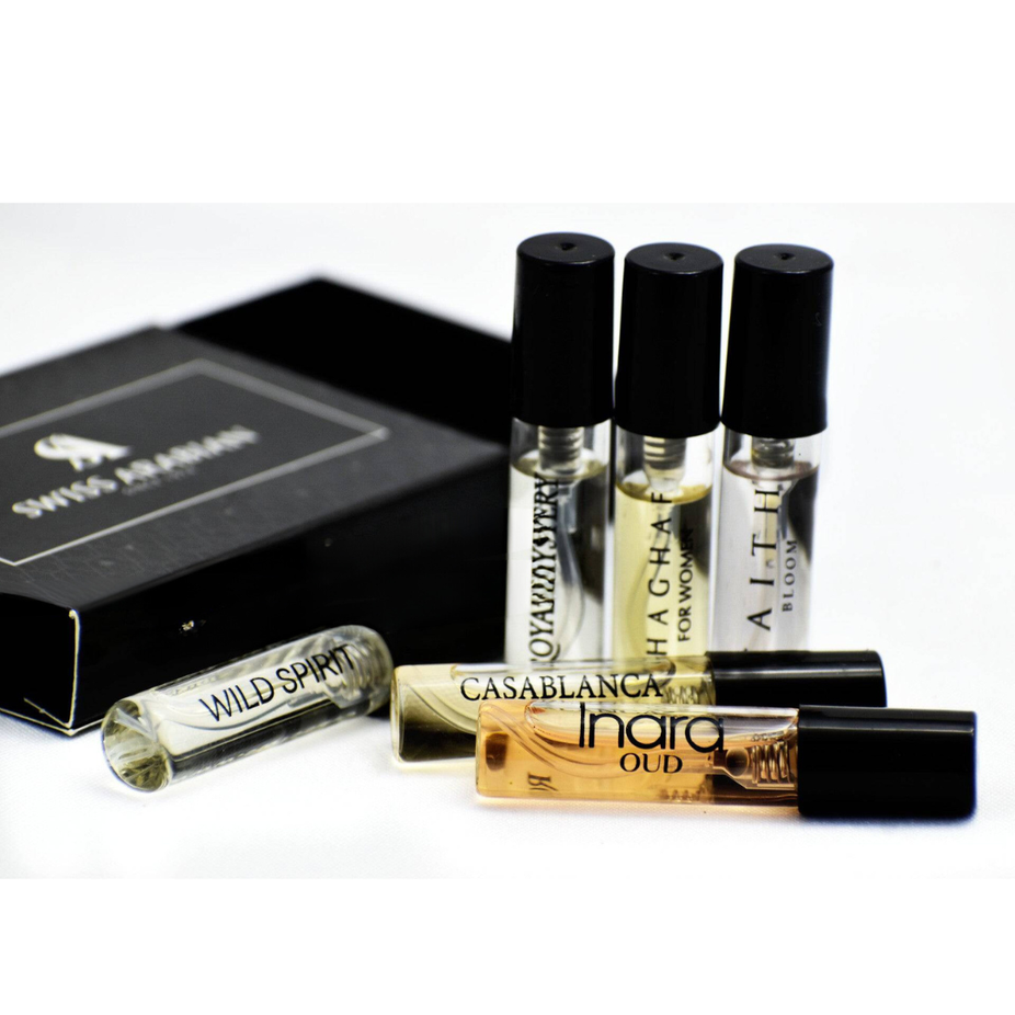 Assorted Swiss Arabian perfume samples including Royal Mystery, Inara, Faith Bloom, Casablanca, Shaghaf W, and Wild Spirit bottles.