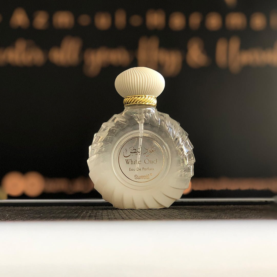White Oud Eau de Parfum spray by Surrati, 100ml bottle, showcasing elegant white packaging and fragrance details.