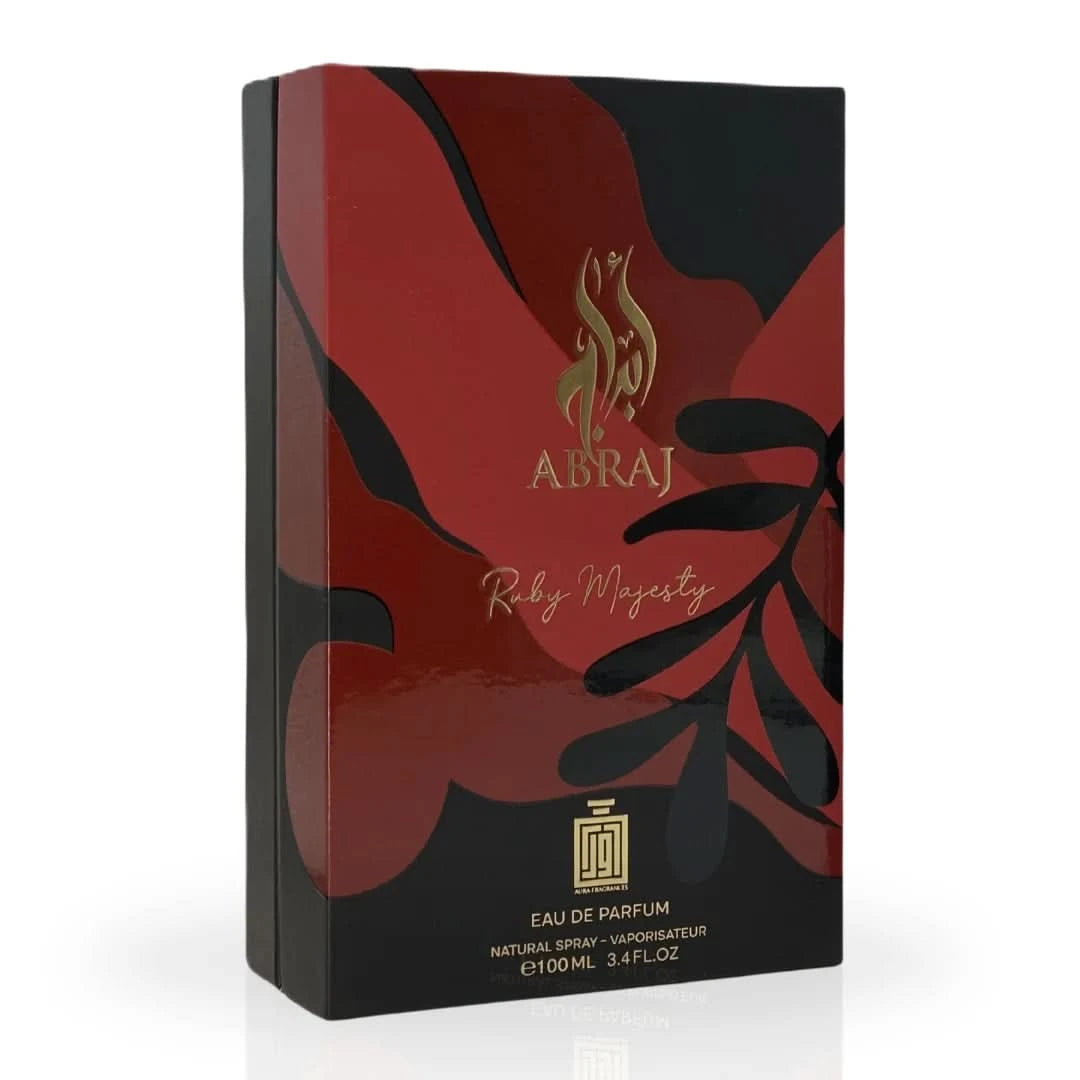 Aura Fragrances Abraj Ruby Majesty Eau De Parfum spray 100ml bottle on a reflective surface with elegant packaging.