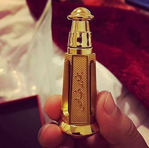 Bakhoor Khas perfume oil by Ajmal in a 3ml glass bottle with a gold cap, showcasing the luxurious fragrance packaging.