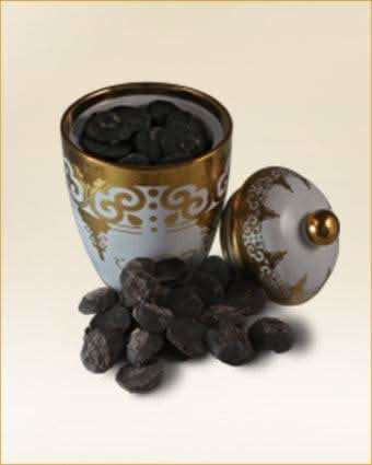 Ajmal Dakhoon Isar Bakhoor 125g container with aromatic traditional incense for home use.