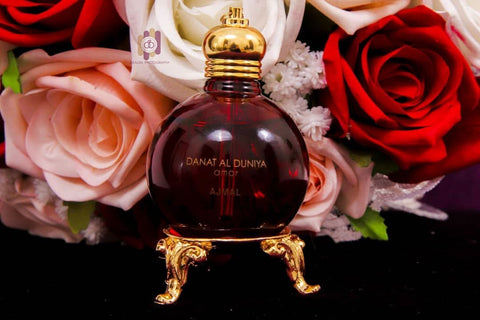 Ajmal Danat al Dunya Amor perfume oil in 30ml bottle inside a velvet pouch, featuring elegant packaging and luxurious design.