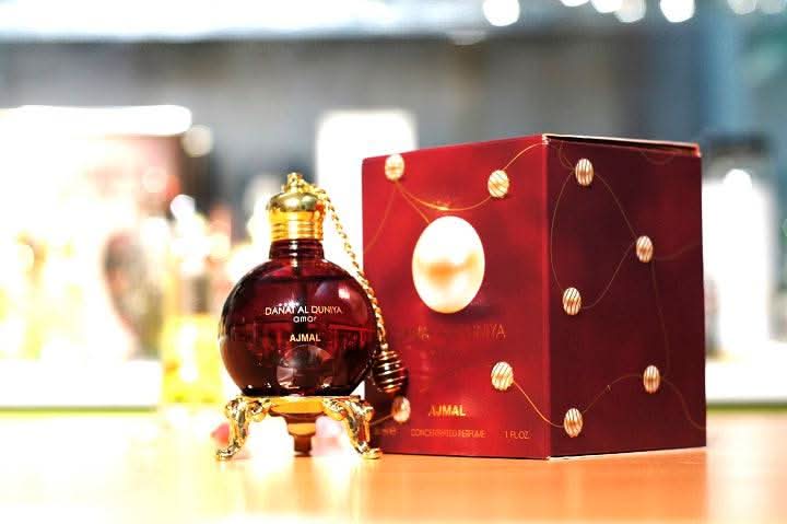 Ajmal Danat al Dunya Amor perfume oil in a 30ml bottle with a silver cap, featuring elegant packaging and a luxurious fragrance.