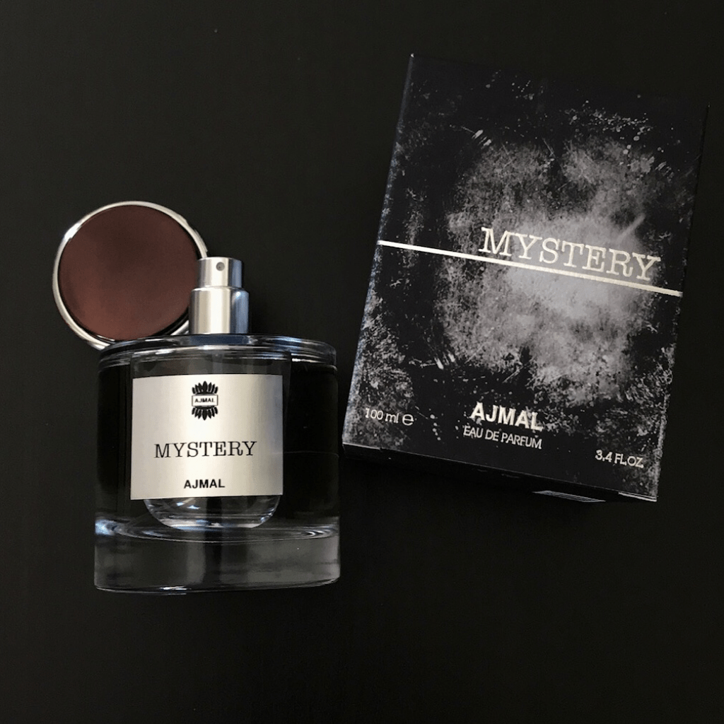 Ajmal Mystery for Men Eau De Parfum 100ml bottle with box, featuring sleek design and dark fragrance notes.