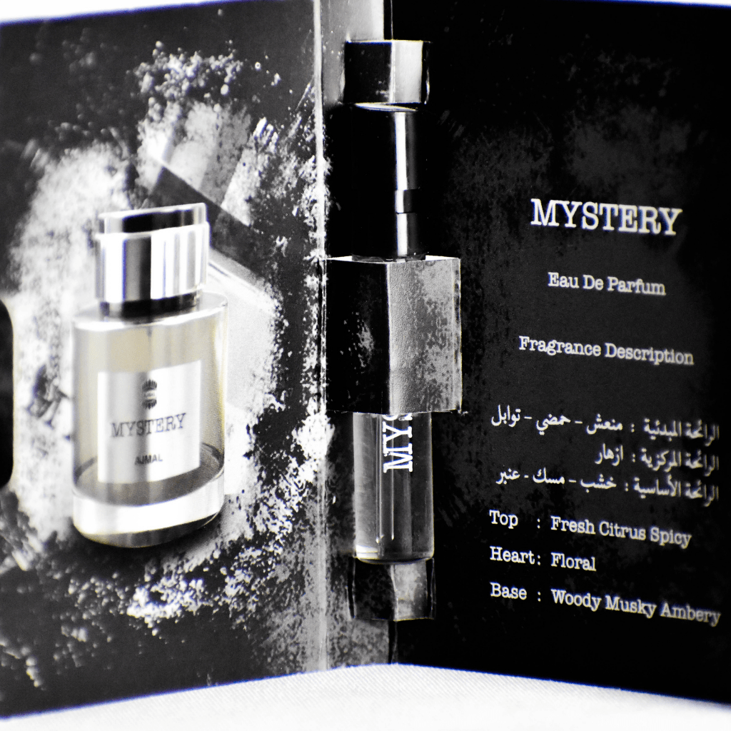 Small 1ml Ajmal Mystery EDP perfume sample vial for men, featuring a clear glass bottle with a black cap.