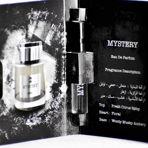 Small 1ml Ajmal Mystery EDP perfume sample vial for men, featuring a clear glass bottle with a black cap.