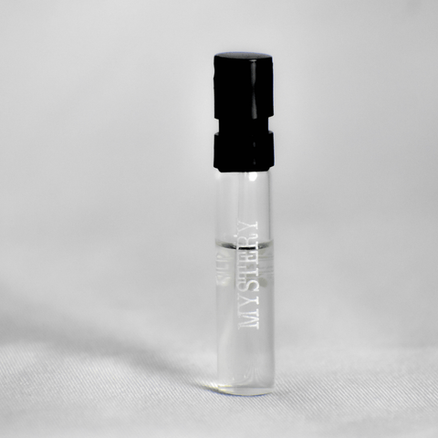 Ajmal Mystery EDP sample vial for men, 1ml, with black cap, showcasing a compact fragrance sample for personal use.