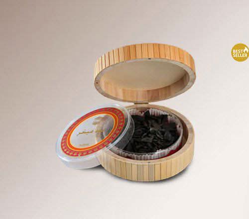 Ajmal Oud Mubkahar Mabkhara Bakhoor in a 50g container with oud chips, traditional incense for aromatic home fragrance.