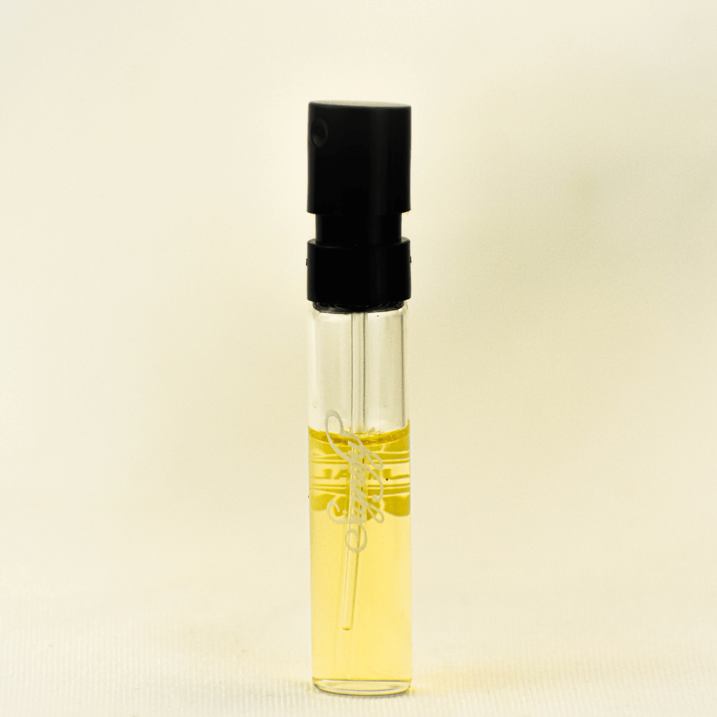 Ajmal Signify EDP sample for women in a 1ml vial, featuring a label with fragrance details and branding.