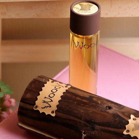 Arabian Oud Woody EDP Eau De Parfum 100ml bottle with wooden accents and elegant packaging, showcasing a luxurious scent experience.