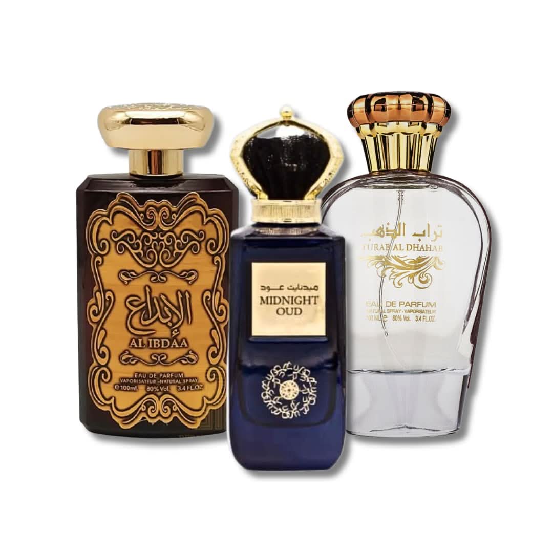 Three 100ml Ard Al Zaafaran Al Ibdaa Gold, Midnight, and Turab Al Dhahab Eau De Parfum bottles with elegant packaging