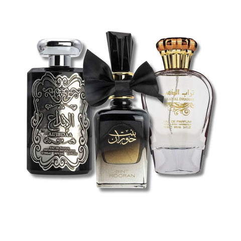 Three 100ml Ard Al Zaafaran Eau De Parfum bottles: Al Ibdaa Silver, Bint Hooran, and Turab Al Dhahab with elegant packaging.