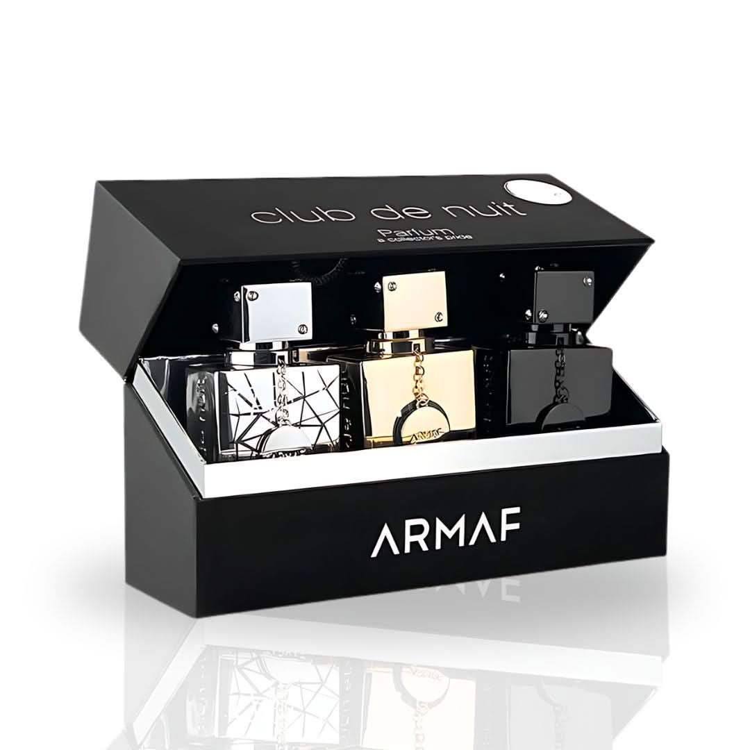 Armaf Club De Nuit Collector's Pride 3-piece 30ml Eau de Parfum gift set with bottles displayed on a reflective surface.