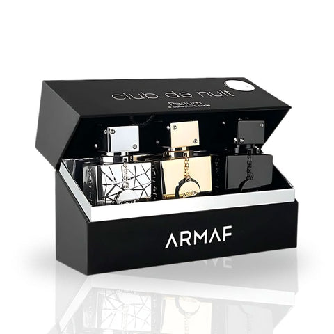 Armaf Club De Nuit Collector's Pride 3-piece 30ml Eau de Parfum gift set with bottles displayed on a reflective surface.