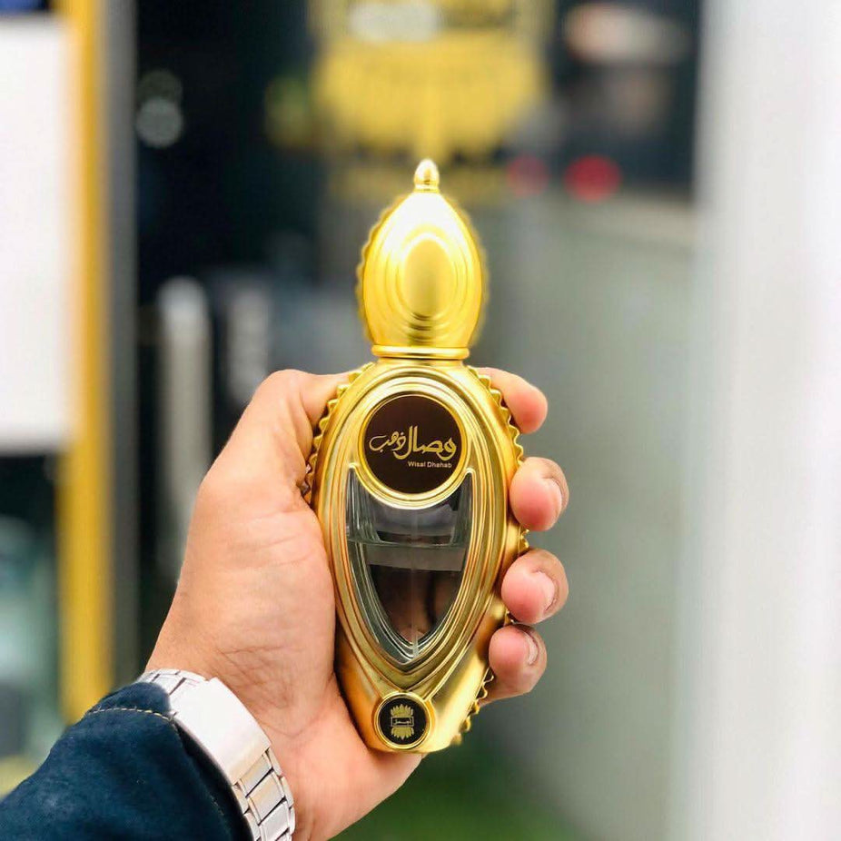 Wisal Dhahab Eau de Parfum spray by Ajmal, 50ml bottle with elegant gold and black packaging, luxurious fragrance design.