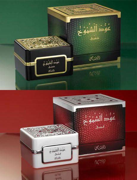 Silver and gold Bakhoor Oudh Al Shomoukh by Rasasi, 35g, featuring ornate packaging with traditional design and fragrant incense content.
