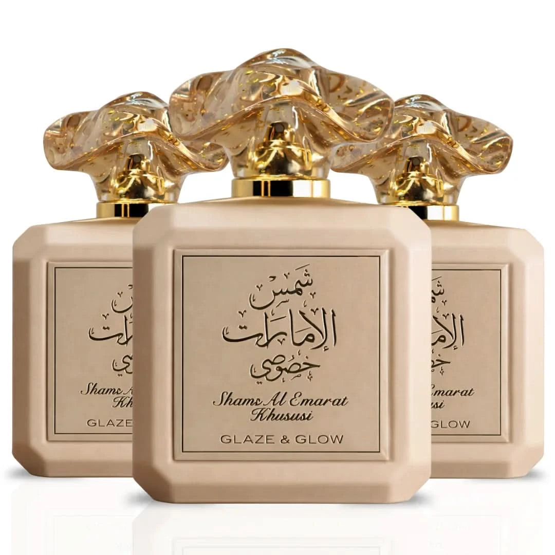 Three bottles of Ard Al Zaafaran Shams Al Emarat Khususi Glaze & Glow Eau De Parfum sprays, 100ml each, with elegant packaging.