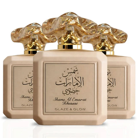 Three bottles of Ard Al Zaafaran Shams Al Emarat Khususi Glaze & Glow Eau De Parfum sprays, 100ml each, with elegant packaging.