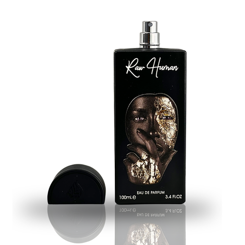 Raw Human EDP by Lattafa Pride in a 100ml bottle with a velvet pouch, showcasing elegant perfume packaging and design.