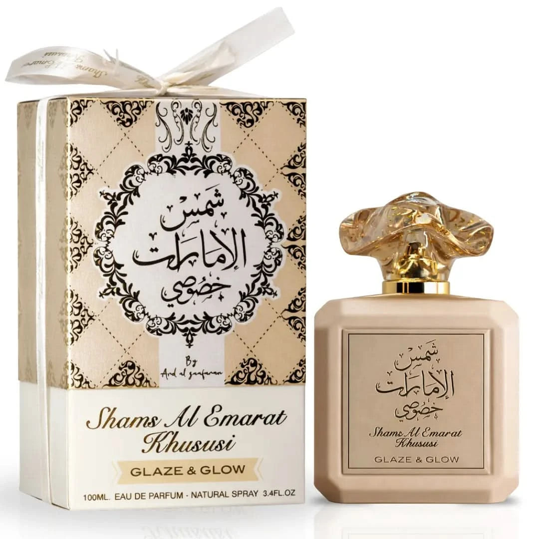 Set of three Ard Al Zaafaran Shams Al Emarat Khususi Glaze & Glow Eau De Parfum sprays 100ml bottles on a sleek display