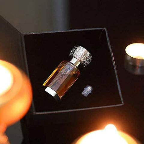 Swiss Arabian Private Musk perfume oil in a 12ml bottle, displayed with a velvet pouch, showcasing concentrated perfume oil packaging.