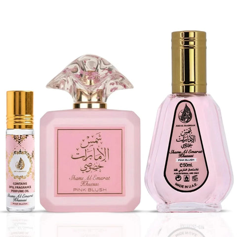 Bundle of Ard Al Zaafaran Pink Blush Shams Al Emarat perfume spray 100ml, 50ml, and 10ml roll-on oil, featuring elegant perfume bottles.