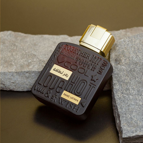 Lattafa Ramz Lattafa Gold Women Eau De Parfum 100ml with velvet pouch, featuring elegant perfume bottle and gold accents.