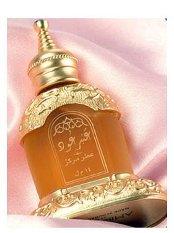 Amber Ood perfume oil by Rasasi in a 14 ML bottle, shown with a velvet pouch, highlighting the concentrated perfume oil packaging.