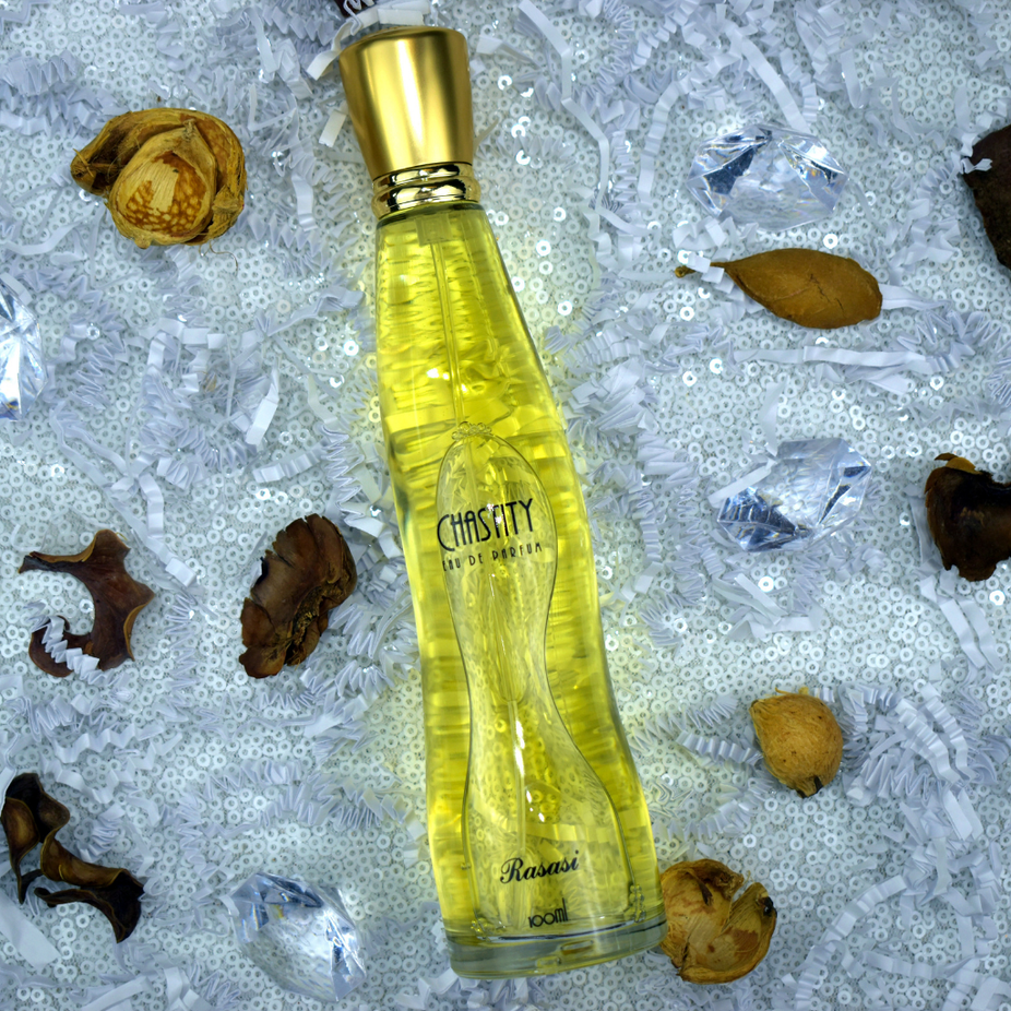 Rasasi EDP for Women 100ml fragrance bottle with matching pouch, elegant floral design and clear perfume liquid visible.