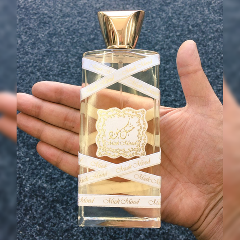 Lattafa Musk Mood EDP 100ml perfume bottle with velvet pouch, floral and musky scent, elegant glass packaging.