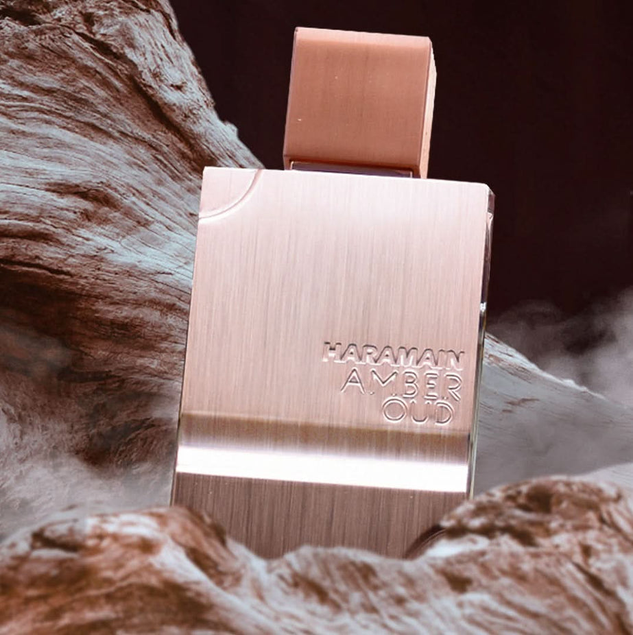 Al Haramain Amber Oud Eau De Parfum bottle with amber-colored liquid in a 60ml (2 oz) glass spray bottle.